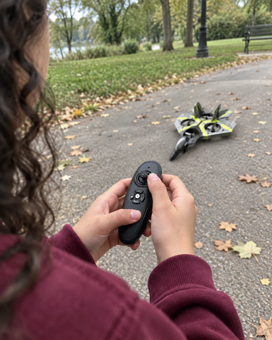 Close view of the handheld remote with the grey and yellow airplane on the ground ahead