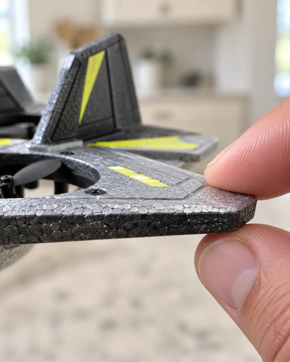 Close-up of the gray and yellow airplane’s textured foam wing